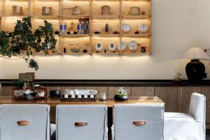 a dining room with a table with chairs and plates at Silent NOISELESS Homestay in Lijiang +139 photos