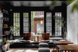 a rendering of a room with tables and windows at Lijiang Old Town Noiseless Zen Courtyard in Lijiang