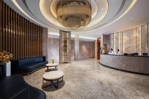 深セン市にあるMotri莫里宝乐城市酒店の天井の高いホテルのロビー