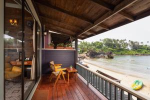 a balcony of a house with a view of the beach at The Ark Comforts in Palolem +92 photos