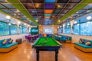 a billiard room with a pool table and couches at goSTOPS Mussoorie Clock Tower in Mussoorie