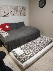 a bed with a blanket on the floor in a room at Luxury 1br apartment in Liminka