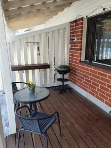 a porch with a table and chairs and a grill at Luxury 1br apartment in Liminka +20 photos