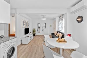 a white living room with a white table and chairs at Casa Los Naranjos in Marbella