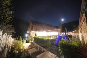 a playground in a yard at night with a barn at MaRu House in Dilijan
