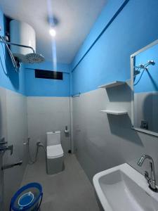 a bathroom with a white toilet and a sink at PHL homestay in Pynursla
