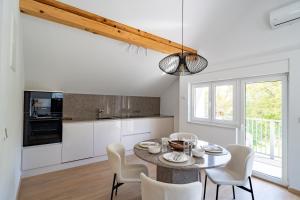 a kitchen and dining room with a table and chairs at Villa Peregrine Plitvice Lakes 