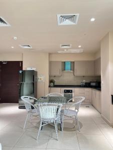 a kitchen with a table and chairs in it at 1 Constitution Avenue By Goldfinch in Islamabad