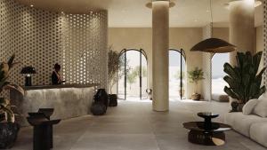 een persoon aan een balie in een lobby bij The Landmark Villas & Spa in Kolimbia