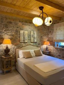 a bedroom with a large bed and two lamps at Villa with private pool and stunning sea view in Galaxidhion