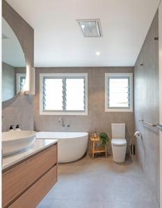 a bathroom with a tub and a sink and a toilet at VINTAGE VISTA RESORTs in Chennai