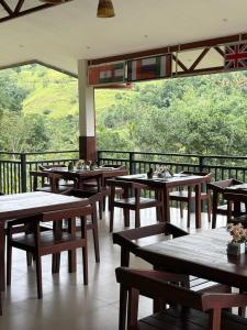 a restaurant with tables and chairs and a large window at Mount Rivera in Atabage Pallegama +51 photos