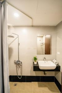 a bathroom with a sink and a shower at Vari Homestay Đội Cấn in Hanoi +15 photos