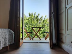 a room with a door open to a balcony with a view at Affittacamere Su Maistu e Linna in Cardedu +17 photos