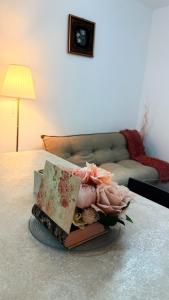 a pile of books sitting on top of a table at Julia Militari Studio in Roşu
