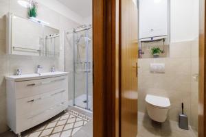 a bathroom with a toilet and a sink and a shower at SOBE FRANO I LOVRO Ck in Crikvenica +69 photos