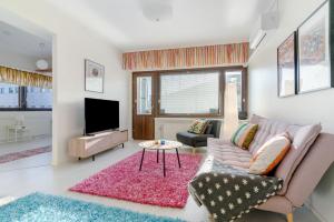 a living room with a couch and a tv at Aurora Atelier in Rovaniemi