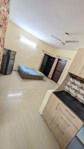 a living room with two beds and a ceiling at Meera 1 bhk Palace Omaxe in Vrindāvan