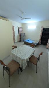 a dining room with a white table and chairs at Meera 1 bhk Palace Omaxe in Vrindāvan