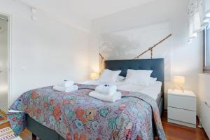 a bedroom with a bed with towels on it at Aurora Atelier in Rovaniemi