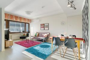 a living room with a couch and a table at Aurora Atelier Design Apartment in Rovaniemi