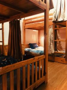 a room with two bunk beds and a couch at Dalat Peace Backpackers Hostel in Da Lat