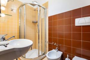 a bathroom with a shower and a sink and a toilet at Helios Vacanze in Conversano