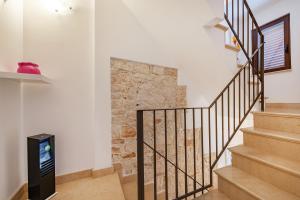 a staircase in a home with a stone wall at Helios Vacanze in Conversano