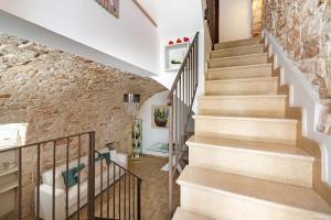 a staircase in a home with a stone wall at Helios Vacanze in Conversano
