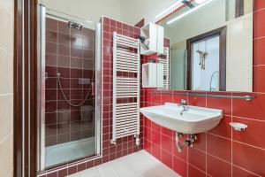 a red bathroom with a sink and a shower at Helios Vacanze in Conversano +30 photos