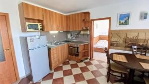 a kitchen with a refrigerator and a table with a dining room at Family 2BDR Apartment in the City Center in Sveti Vlas
