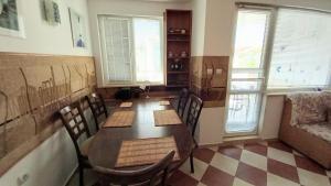 a dining room with a table and chairs and windows at Family 2BDR Apartment in the City Center in Sveti Vlas +23 photos