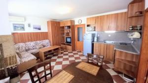 a kitchen and a living room with a couch at Family 2BDR Apartment in the City Center in Sveti Vlas