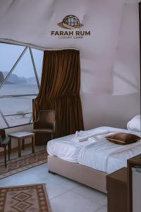 a bedroom on a boat with a bed and a chair at FARAH RUM lUXURY CAMP in Wadi Rum