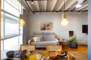 un salon avec un canapé et une table dans l'établissement Copan Castelli Studios SP, à São Paulo