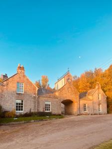 an old brick building with a tunnel in front of it at Brylach Steading in Aberlour