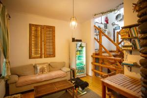 a living room with a couch and a refrigerator at Casa Mosului - Transfăgărășan Bed & Breakfast in Cîrţişoara