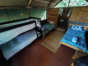 an overhead view of a room with two beds and a bench at Amangwane Tented Camp in Enkovukeni