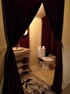 a bathroom with a sink and a toilet in a tent at enjoy best night in desert merzouga in Merzouga