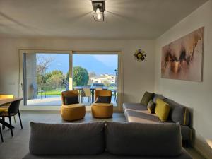 a living room with a couch and two chairs at Villa Tarca - Colico, Lake Como in Colico +33 photos
