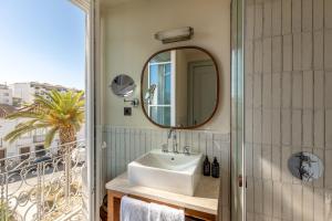 a bathroom with a sink and a mirror at Palácio de Tavira, a Small Luxury Hotel of the World in Tavira +77 photos