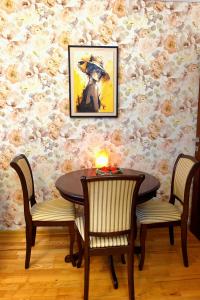 a dining room with a table and two chairs at Tatra Apartment Palace Hill with angels and sauna in Poprad