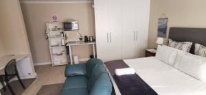 a small living room with a couch and a kitchen at Mila's at Panorama in Panorama