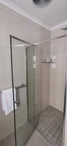 a shower with a glass door in a bathroom at Mila's at Panorama in Panorama