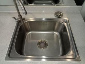 a stainless steel sink in a kitchen at City & River Views near Royal Palace and Watphnom in Phnom Penh +11 photos