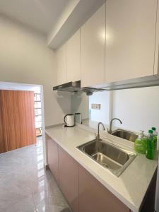 a kitchen with a sink and a counter top at City & River Views near Royal Palace and Watphnom in Phnom Penh