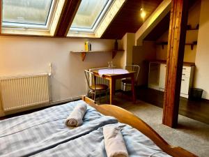 a bedroom with a bed and a table with a tableasonable at Dom Siedlisko Przesieka koło Karpacza in Przesieka