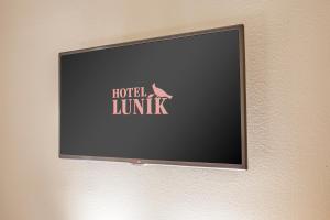 a sign on a wall with a picture of a cat on it at Hotel Lunik in Prague