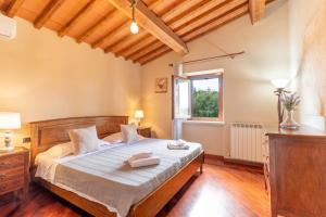 a bedroom with a bed and a window at Pieve Vecchia, Luxury Tuscan Retreat with Spa in Campagnatico +47 photos