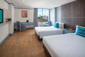 Postel nebo postele na pokoji v ubytování King Park Avenue Hotel Bangkok